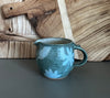 handmade pottery creamer with floral design