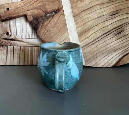 handmade pottery creamer with floral design