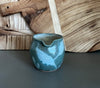 handmade pottery creamer with floral design