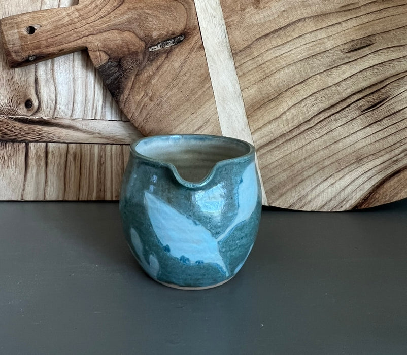 handmade pottery creamer with floral design
